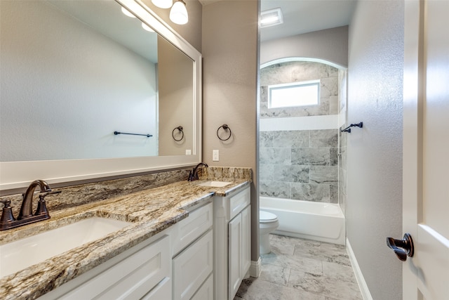 full bathroom featuring vanity, toilet, and tiled shower / bath combo