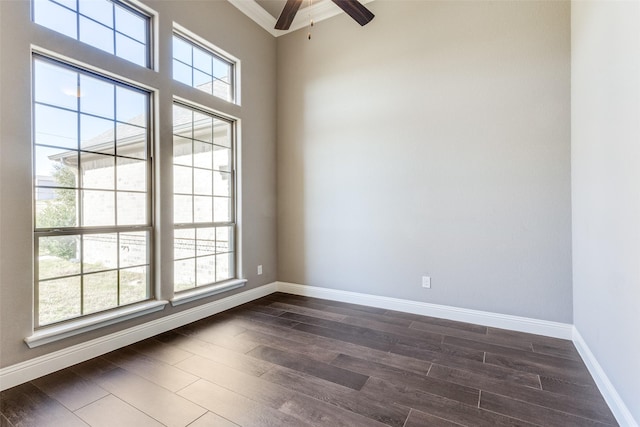 spare room featuring a healthy amount of sunlight, dark hardwood / wood-style floors, and ceiling fan