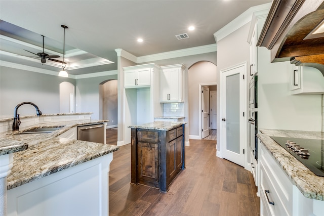 kitchen featuring sink, a center island with sink, appliances with stainless steel finishes, light stone countertops, and white cabinets