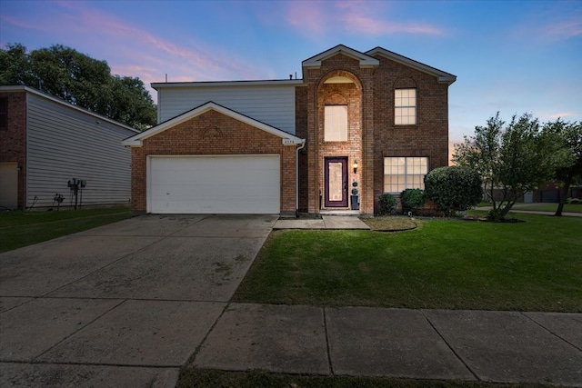 front facade with a garage and a lawn