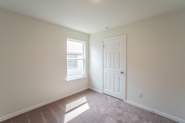 unfurnished room with light carpet