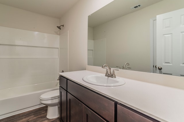 full bathroom with shower / bathing tub combination, wood-type flooring, vanity, and toilet