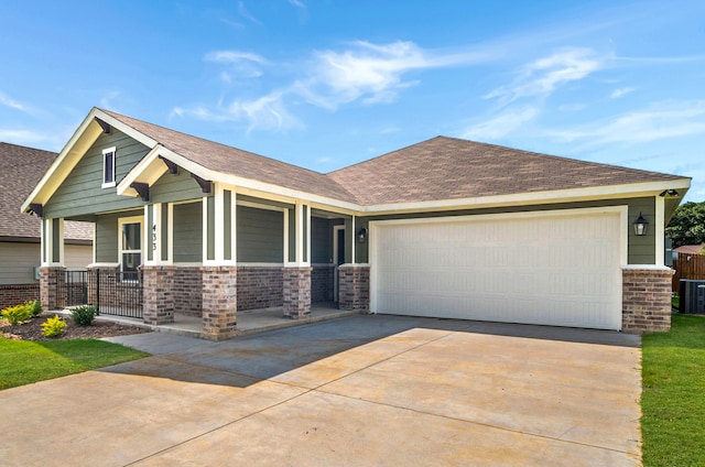 craftsman-style home featuring covered porch and a garage