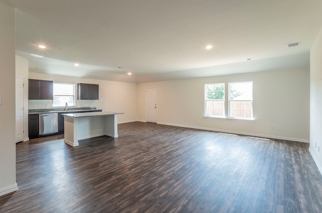 kitchen featuring a kitchen island, a wealth of natural light, and dark wood-type flooring