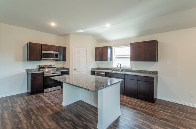 kitchen with a center island, dark hardwood / wood-style flooring, dark brown cabinetry, and stainless steel appliances