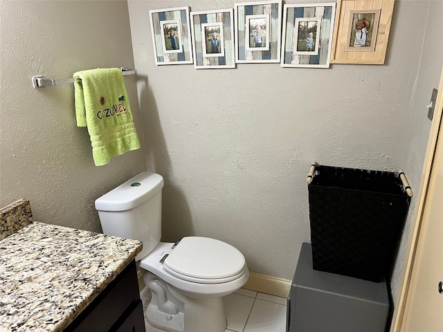 bathroom with tile patterned floors, vanity, and toilet