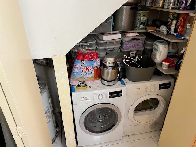 washroom featuring washer and clothes dryer and light tile patterned floors