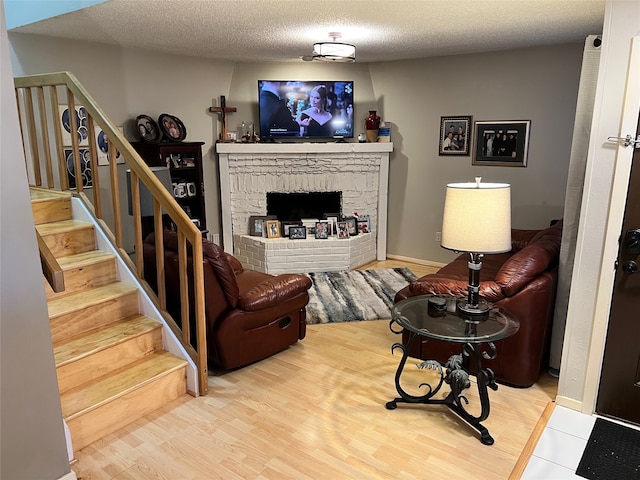 living room featuring a textured ceiling and light wood-type flooring