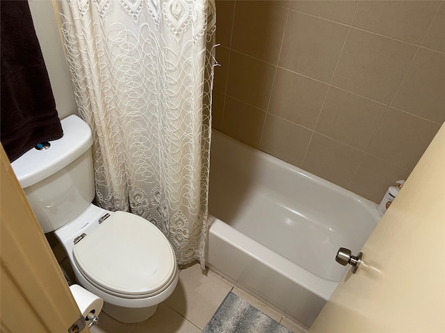 bathroom with tile patterned floors, shower / bath combo with shower curtain, and toilet