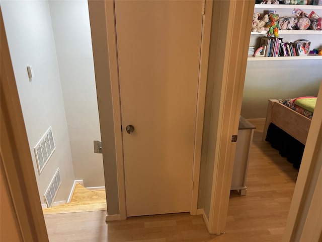 hallway with light hardwood / wood-style flooring