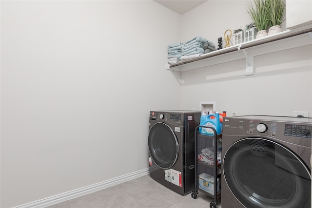 clothes washing area with light tile patterned flooring and independent washer and dryer