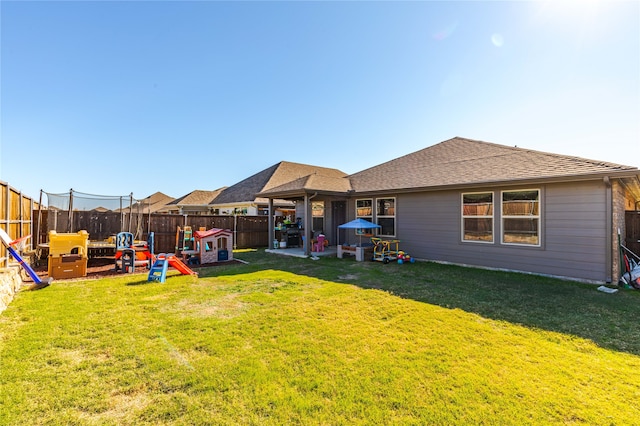 view of yard with a trampoline, a patio area, and a playground