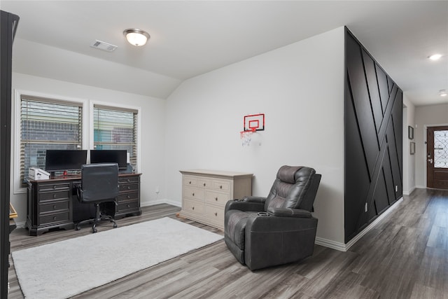 home office with lofted ceiling and dark wood-type flooring