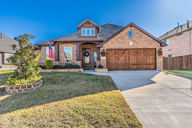 view of front of property featuring a garage and a front yard