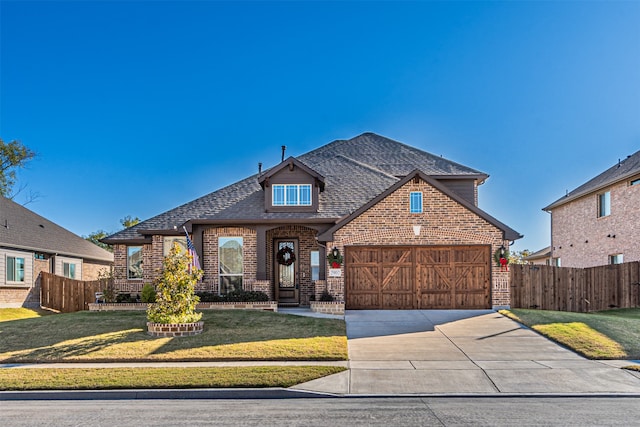 view of front of home with a front lawn and a garage