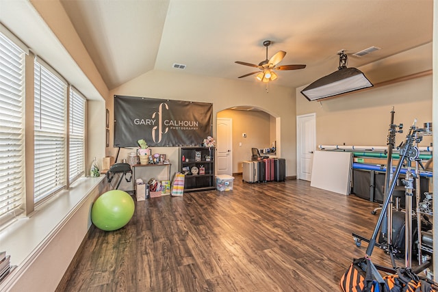 workout room featuring ceiling fan, dark hardwood / wood-style flooring, and lofted ceiling