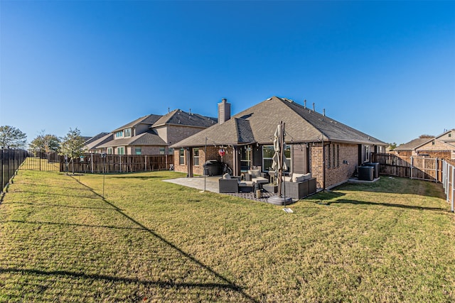 back of property with a lawn, an outdoor hangout area, a patio, and central AC