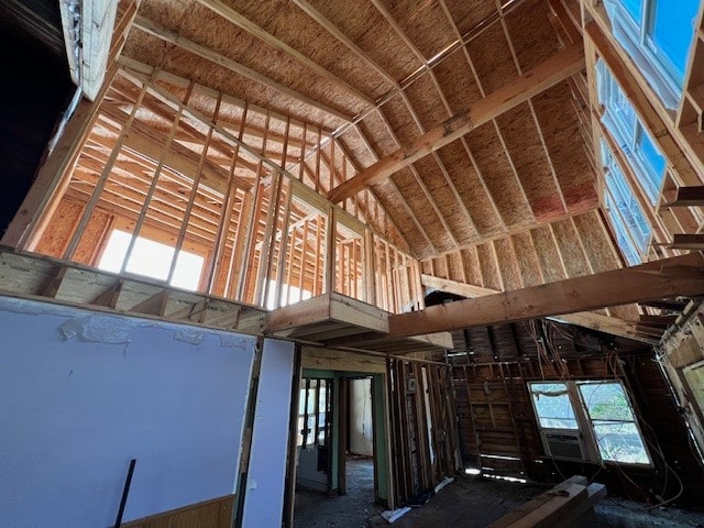 miscellaneous room featuring lofted ceiling and cooling unit