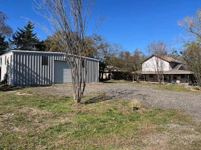 view of yard featuring a garage and an outdoor structure