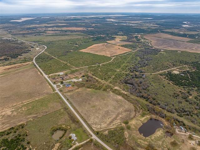 drone / aerial view featuring a rural view and a water view