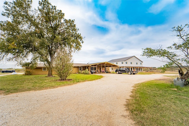 view of front of property featuring a front yard and a carport