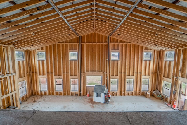 miscellaneous room with a healthy amount of sunlight and a high ceiling