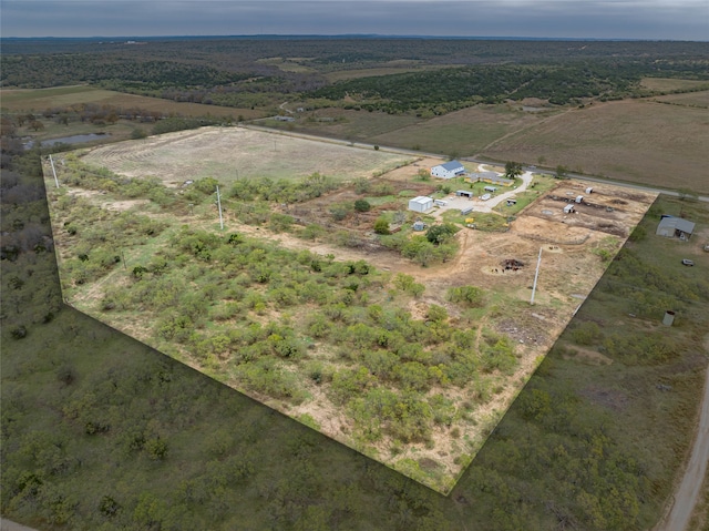 birds eye view of property with a rural view