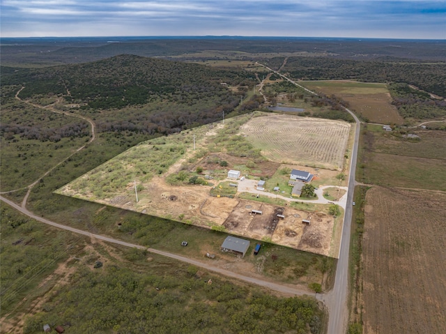 birds eye view of property with a rural view