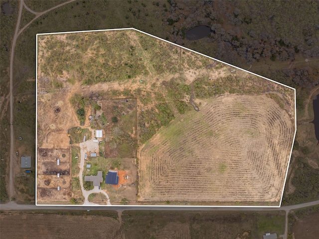 birds eye view of property with a rural view