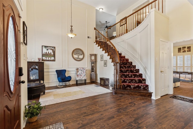 foyer entrance featuring hardwood / wood-style flooring and a high ceiling