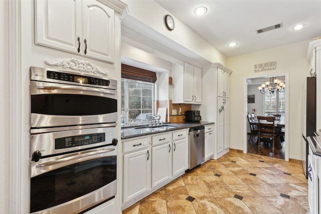 kitchen with white cabinets, plenty of natural light, and stainless steel appliances