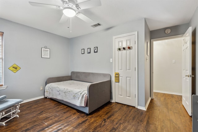 sitting room with ceiling fan and dark wood-type flooring