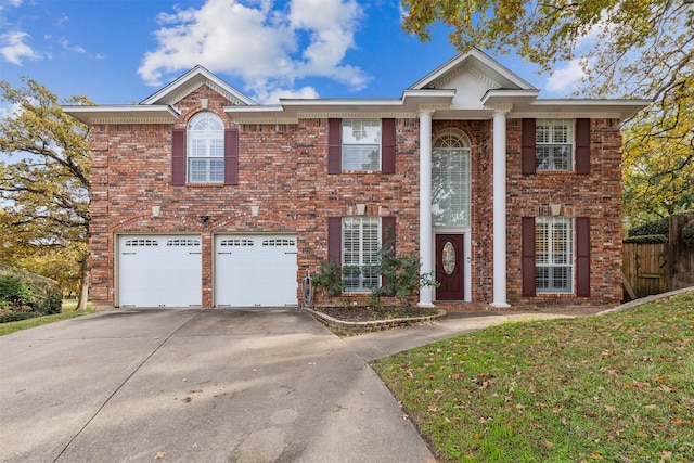 view of front of property featuring a garage and a front lawn