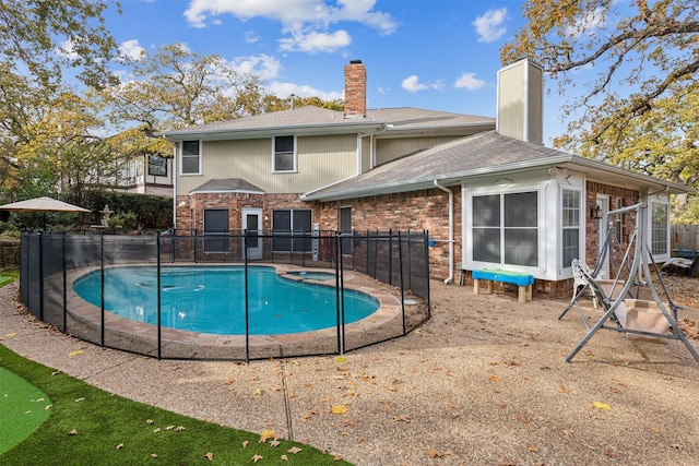 view of swimming pool featuring an in ground hot tub