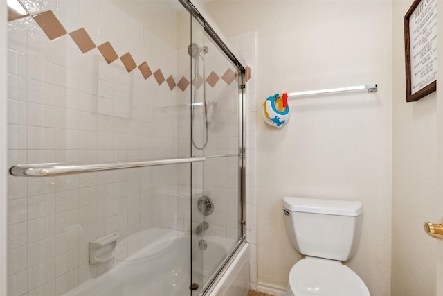 bathroom with toilet and enclosed tub / shower combo