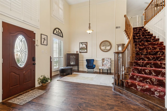 entryway featuring dark wood-type flooring and a high ceiling