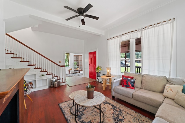 living room featuring beam ceiling, hardwood / wood-style flooring, and ceiling fan