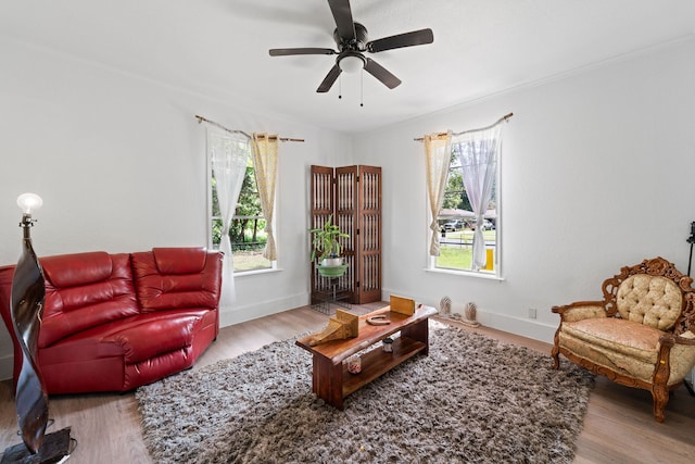 living room featuring ceiling fan and light hardwood / wood-style flooring