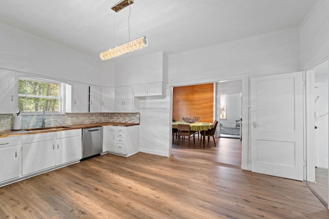 kitchen featuring pendant lighting, dishwasher, sink, light wood-type flooring, and white cabinetry