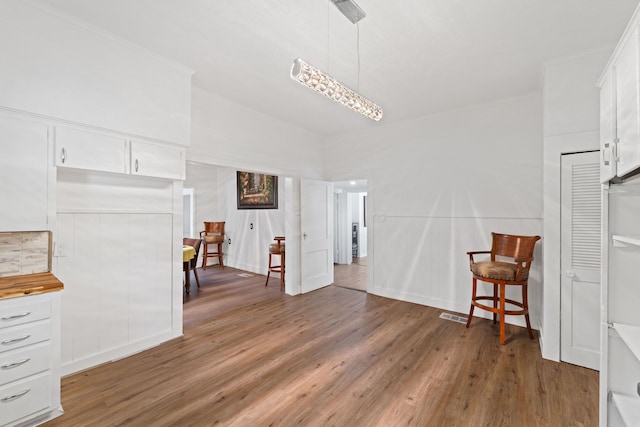 interior space featuring dark hardwood / wood-style floors and crown molding