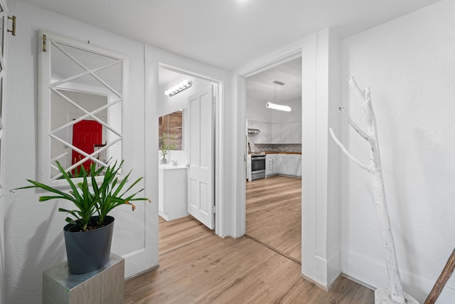 corridor featuring light hardwood / wood-style floors