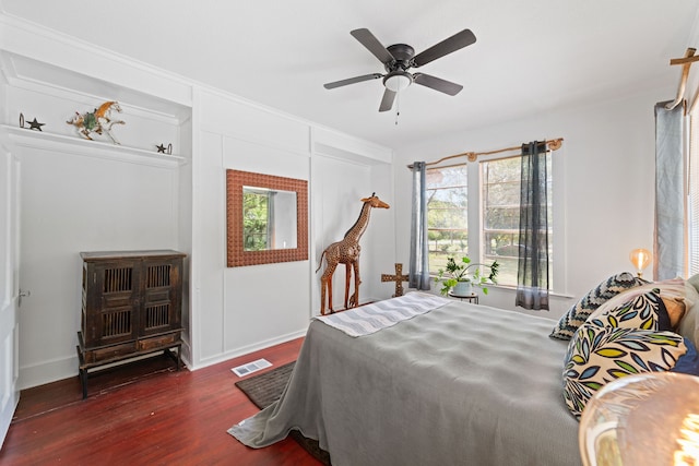 bedroom with dark hardwood / wood-style flooring and ceiling fan