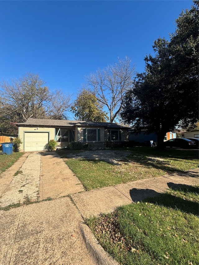 4848 Haas Dr, Dallas, TX 75216 - view of front of house featuring a garage and a front lawn