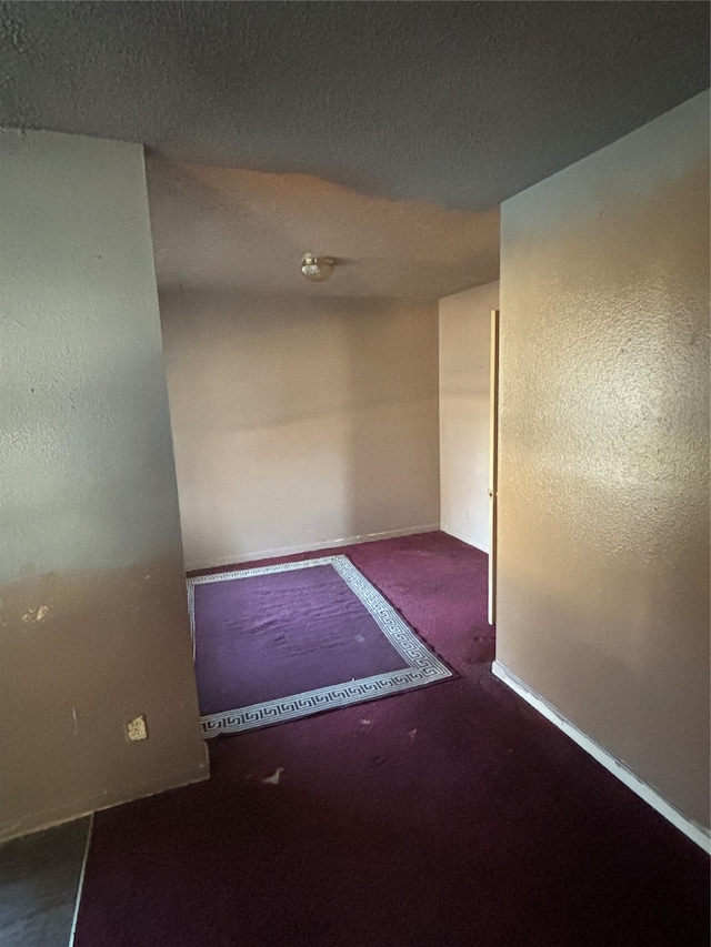 4848 Haas Dr, Dallas, TX 75216 - empty room with dark colored carpet and a textured ceiling