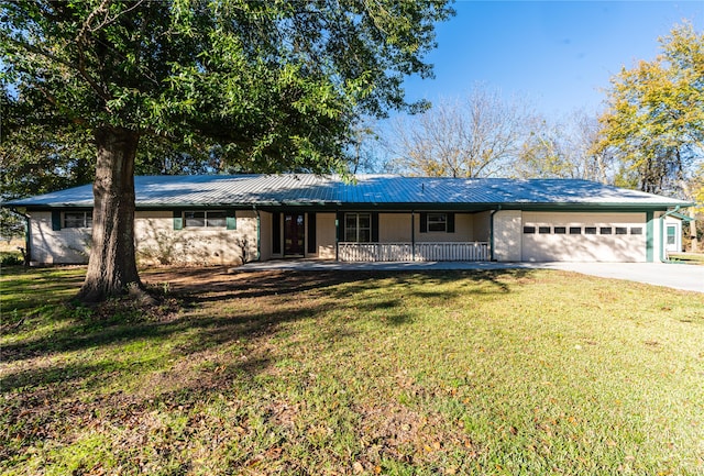 single story home with covered porch, a front yard, and a garage