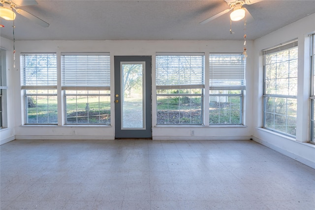 unfurnished sunroom featuring ceiling fan