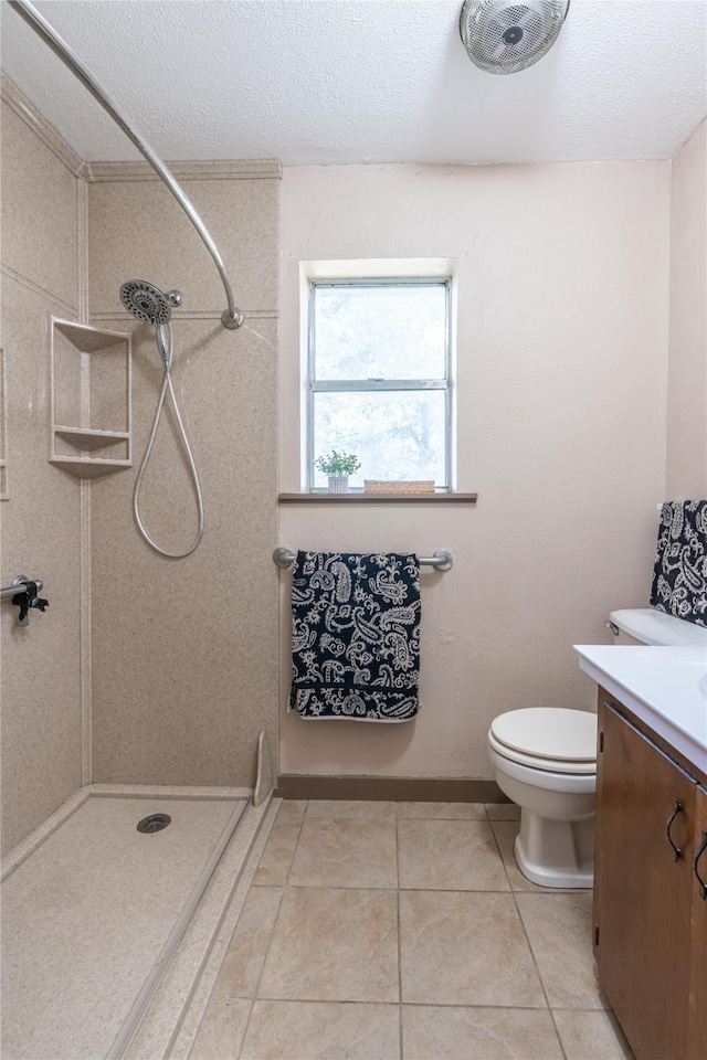 bathroom with tile patterned floors, walk in shower, a textured ceiling, vanity, and toilet