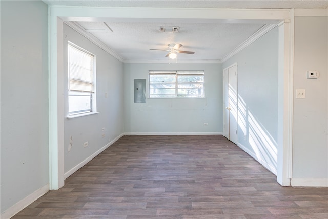 empty room with electric panel, ceiling fan, hardwood / wood-style floors, and crown molding