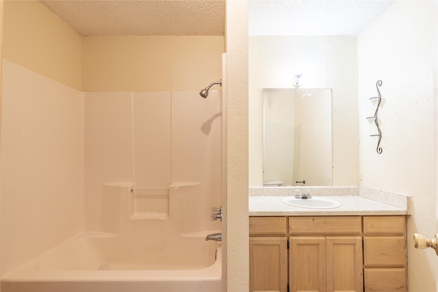 full bathroom with vanity, shower / bath combination, a textured ceiling, and toilet