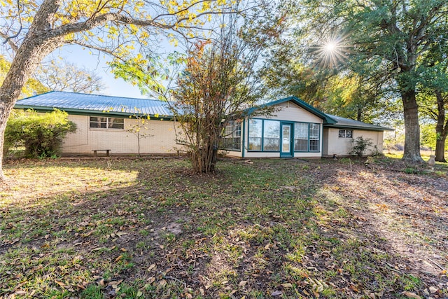 back of property with a sunroom